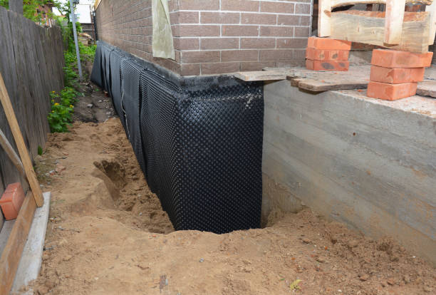 Happy homeowners after waterproofing job in Boaz